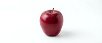 Fresh red apple with water droplets isolated on white background, suitable for food, nutrition, health and wellness design projects.