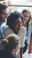Diverse team of young professionals laughing during creative brainstorming session in modern office space, showcasing collaboration and workplace joy.