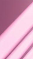 Soft diagonal light rays create gentle gradient from deep mauve to pale pink, casting ethereal shadows across minimal background for modern design projects.