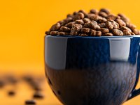 Chocolate cereal in dark blue bowl against yellow background, ready for breakfast food photography, advertising, packaging design, and culinary content.