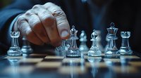 Hand moving glass chess piece on board with dramatic lighting and selective focus, showcasing strategy and decision-making in competitive gameplay.