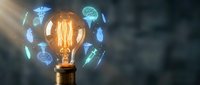 Glowing vintage light bulb surrounded by floating medical and healthcare icons including caduceus, brain, DNA helix and stethoscope representing innovation.