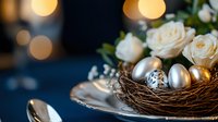Elegant Easter composition with silver and gold eggs in natural nest, white roses, and soft bokeh lights on dark blue background. Festive table setting.