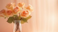 Delicate peach roses in clear glass vase against soft coral background with gentle natural lighting creates romantic, dreamy atmosphere for wedding and home decor.