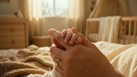 Hands clasped together in prayer or meditation in warm sunlit bedroom creating peaceful morning atmosphere for spiritual wellness and mindfulness practices.