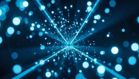 Abstract blue light burst with radiating beams and glowing particles creating dynamic energy explosion effect for digital backgrounds and presentations.