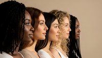 Diverse group of five young women in profile showing different ethnicities and hairstyles representing unity, diversity and sisterhood in modern society.