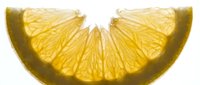Sliced lemon wedges with translucent yellow flesh and visible segments isolated on white background, suitable for food and beverage design projects.