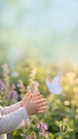 Child hands reaching toward magical butterfly in dreamy garden with soft bokeh light and purple wildflowers creating peaceful nature scene.