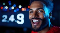 Young African American man smiling with joy against blurred city lights and numbers background. Happy male portrait with bokeh urban nighttime scene.