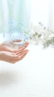 Cupped hands releasing glowing compass and directional symbols representing guidance, navigation and spiritual journey in soft natural light.