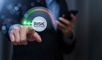 Businessman touching digital risk management gauge interface with colorful indicator scale showing security assessment levels for corporate decision making.