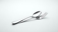 Shiny stainless steel spoon and fork crossed on white background, elegant silverware set for restaurant menu, food blog, or kitchen design.