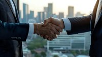 Business professionals in suits shaking hands against urban cityscape background during sunset, symbolizing partnership agreement and successful deal closing.