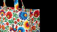 Colorful floral tote bag with vibrant red, blue, and yellow flowers on white background, isolated on transparent background. Ready for print-on-demand, sublimation, and merchandise design.