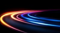 Glowing curved light trails in orange, pink and blue neon colors against dark background create dynamic motion effect for technology and speed concepts.