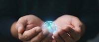Hands holding glowing digital globe with blue light, representing global connectivity, technology innovation, and worldwide business communication for corporate and digital concepts.