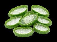 Sliced aloe vera plant with fresh green skin and translucent gel interior, isolated on transparent background. Ready for wellness, beauty, and health design projects.