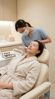 Professional cosmetologist performing facial injection treatment on female client in modern medical spa clinic for anti-aging skincare procedure.