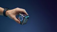 Caucasian male hand holding futuristic holographic cube with glowing digital interface against dark blue background for technology and innovation concepts.