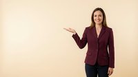 Professional businesswoman in burgundy blazer presenting with open palm gesture against neutral beige background for corporate presentations and marketing.