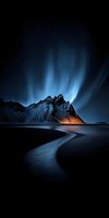 Dramatic aurora borealis dancing over snow-covered mountain peaks reflected in dark ocean waters with starry night sky creating mystical arctic landscape scene.