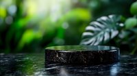 Black marble podium platform with tropical monstera leaves in blurred green jungle background for luxury product display and natural cosmetic presentation.