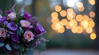 Romantic bouquet of pink and purple roses with eucalyptus against blurred golden bokeh lights background creates dreamy wedding atmosphere.