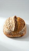 Artisan sourdough loaf with deep scoring and golden-brown crust, showcasing traditional bread-making techniques for bakery, food, and culinary content.