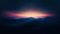 Dramatic sunset over mountain silhouettes with vibrant purple and orange sky creating peaceful landscape scenery for nature and travel content.