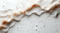 Dramatic abstract background with white and brown marble texture, scattered spices and powder creating dynamic pattern on light surface.