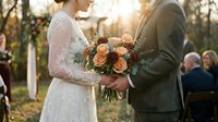 Bride and groom holding wedding bouquet during outdoor ceremony at golden hour with guests in background for romantic celebration photography.