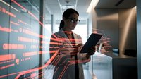 African American businesswoman analyzing data on tablet in modern office with digital interface overlay for corporate technology presentations.