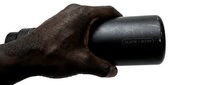 Male hand holding black power tool on white background, isolated for design and commercial use applications.