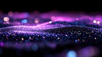 Magical purple and blue glowing particles with bokeh effect on dark background create dreamy abstract landscape with shimmering sparkles and light waves.