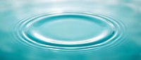 Concentric ripples spread across turquoise water surface, creating circular waves from central impact point. Suitable for wellness, spa, and nature concepts.