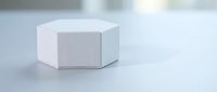 White hexagonal geometric podium platform on clean surface for product display and presentation mockup design.