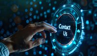 Finger pointing at glowing contact us button on futuristic digital interface with blue technology circles and connection lines in dark background.