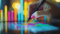 Female hand analyzing colorful financial data charts and graphs with pen on digital screen display, illuminated by vibrant bokeh lights in background.