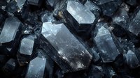 Raw dark crystals with translucent surfaces in macro photography showing natural geometric shapes, rough texture, and light reflections against black background.