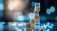 Wooden blocks and transparent glass cubes stacked in ascending steps on reflective surface with bokeh lights background for business growth concept.