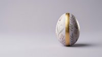 Elegant Easter egg with delicate floral pattern and golden ribbon on soft purple background for spring holiday celebrations and greeting cards.