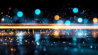 Abstract glowing blue and orange bokeh lights reflected on dark wet surface with sparkles and light streak, creating magical nighttime atmosphere.