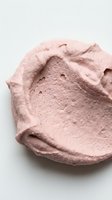 Creamy pink cosmetic product with textured surface and natural swirls, isolated on white background for beauty and skincare design applications.
