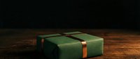 Vintage green leather-bound book with copper clasp resting on aged wooden surface, suitable for literature, education, antique, and library design projects.