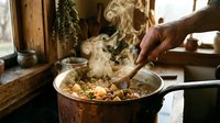 Steaming hot homemade stew being stirred in copper pot with wooden spoon in rustic kitchen setting with natural lighting and cozy atmosphere.