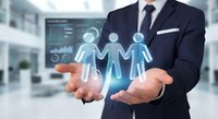 Professional businessman in suit holding glowing digital human resources icons representing team management and corporate leadership in modern office.