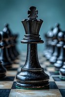 Black chess king piece standing prominently on chessboard with blurred pieces in background, strategic game concept for business and leadership themes.