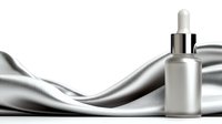 Elegant cosmetic dropper bottle on silver satin fabric background with flowing waves, luxury skincare product presentation for beauty and wellness industry.