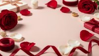 Romantic Valentine's Day frame with red roses, gift boxes, ribbons and scattered petals on pink background for love celebration and holiday design.